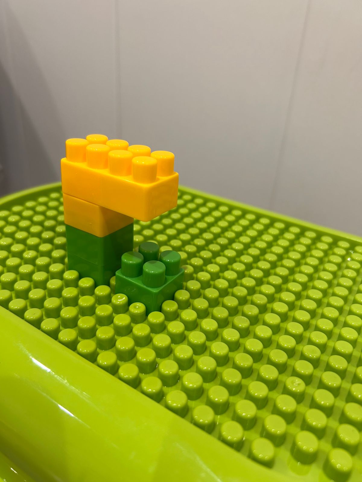 rolling building blocks bin with green build-on lid and wheels